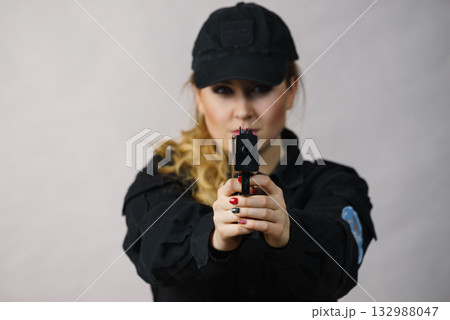 Woman holds gun in hands. Woman holds gun in hands. 132988047