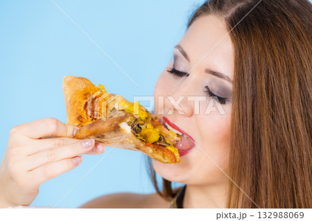 Woman eating hot pizza slice Woman eating hot pizza slice 132988069