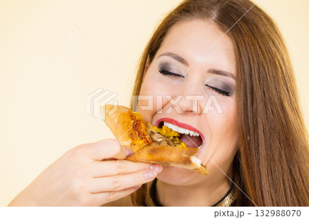 Woman eating hot pizza slice Woman eating hot pizza slice 132988070