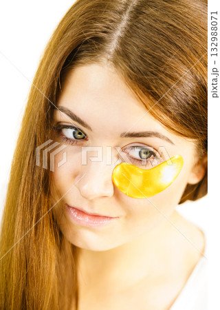 Woman with gold patches under eyes Woman with gold patches under eyes 132988071