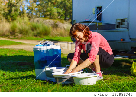 Female washing laundry outdoor at caravan Female washing laundry outdoor at caravan 132988749