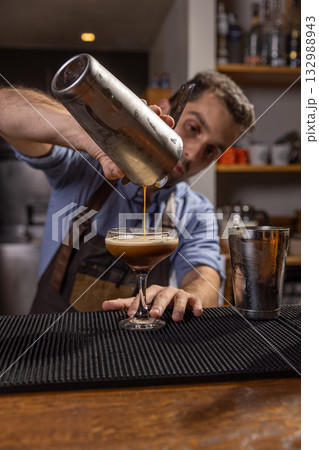 Bartender pouring espresso martini 132988943