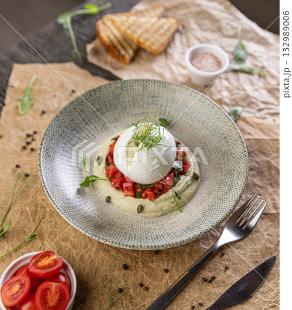 Burrata cheese resting on hummus 132989006
