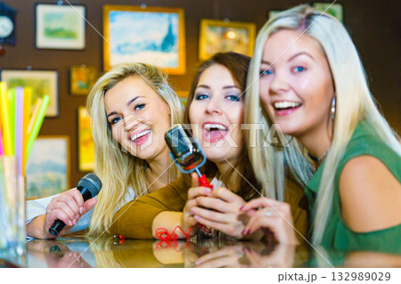 Women singing with microphone Women singing with microphone 132989029