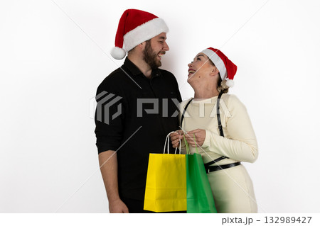A couple is happily holding shopping bags after Christmas shopping. 132989427