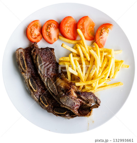 Grilled beef ribs Churasko are garnished with French fries and tomato 132993661