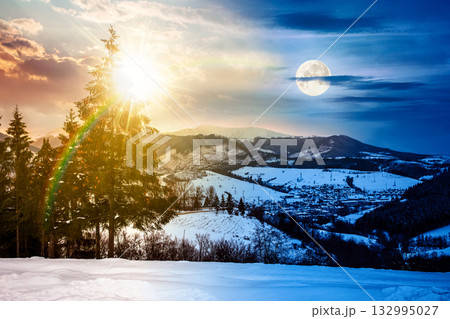 village in mountains. day and night time change concept. winter landscape covered with snow with sun and moon at twilight. trees on rolling hills. duality and transition template village in mountains. day and night time change concept. winter landscape covered with snow with sun and moon at twilight. trees on rolling hills. duality and transition template 132995027