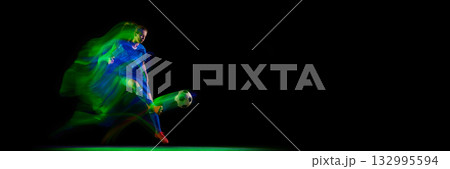 Female athlete controlling soccer ball in turquoise and pink motion light. Banner Female athlete controlling soccer ball in turquoise and pink motion light. Banner 132995594