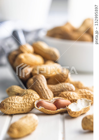 Peanuts in shell. Groundnuts on white table. 132995897