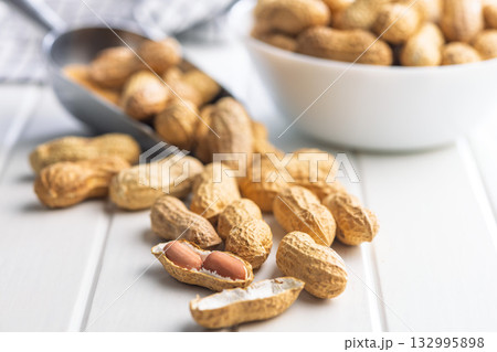 Peanuts in shell. Groundnuts on white table. 132995898