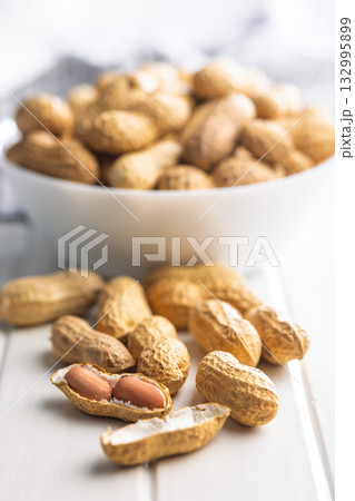 Peanuts in shell. Groundnuts on white table. Peanuts in shell. Groundnuts on white table. 132995899