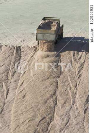 Trucks unloading raw salt bulk, Salinas Grandes Trucks unloading raw salt bulk, Salinas Grandes 132995985