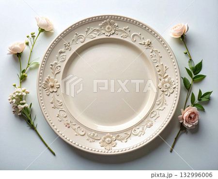 Vintage table setting. Ceramic plate with a classic white design and floral border on a white background. Porcelain kitchenware. Close-up. Top view. 132996006