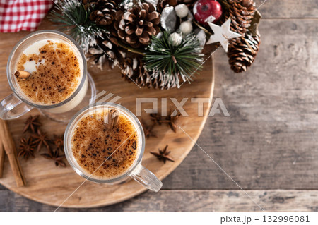Eggnog with Cinnamon and Christmas Decorations Eggnog with Cinnamon and Christmas Decorations 132996081