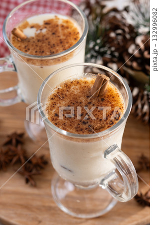 Eggnog with Cinnamon and Christmas Decorations 132996082
