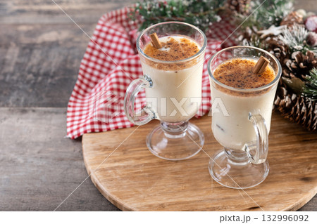 Eggnog with Cinnamon and Christmas Decorations 132996092