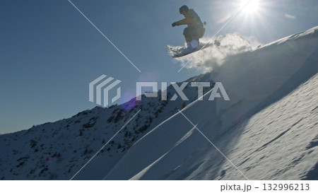 Professional skier performing extreme tricks on snowy mountain peaks Professional skier performing extreme tricks on snowy mountain peaks 132996213