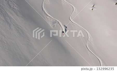 Professional skier making turns on a snowy slope 132996235