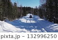 Off-road vehicle driving on snowy forest road in winter 132996250