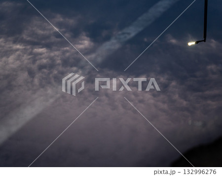 Reflection of street lights and sky on flood puddle on the road Reflection of street lights and sky on flood puddle on the road 132996276