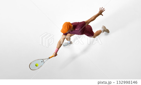 Male tennis player lunging forward for shot showing strong posture and body control Male tennis player lunging forward for shot showing strong posture and body control 132998146