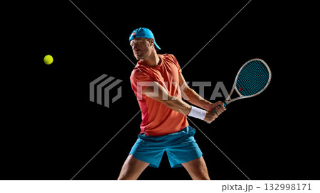 Focused tennis player preparing for backhand return with strong anticipation Focused tennis player preparing for backhand return with strong anticipation 132998171
