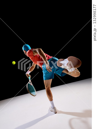 Determined tennis player following ball with focus and body control 132998177
