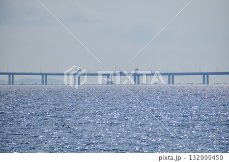 The view of the seascape in Shenzhen Bay with the Shenzhen Bay sea crossing bridge in the background. Seascape view from the shore of Shenzhen, China. Nature and landscape. 132999450