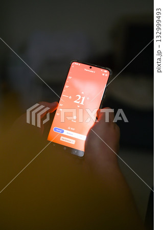 Smartphone connecting to heating system. Remote home control system on a smartphone. smart home Smartphone connecting to heating system. Remote home control system on a smartphone. smart home 132999493