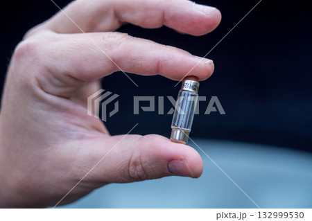 Halogen car new and old lamp bulb. Male hand holding car parts 132999530