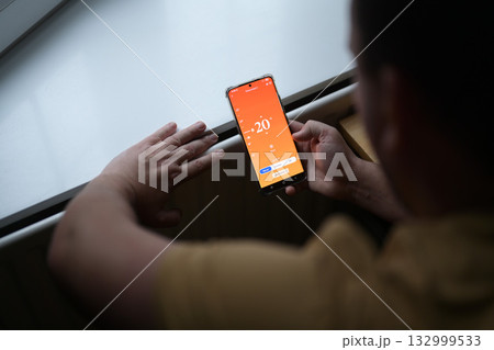 Smartphone connecting to heating radiator. Remote home control system on a smartphone. Smartphone connecting to heating radiator. Remote home control system on a smartphone. 132999533