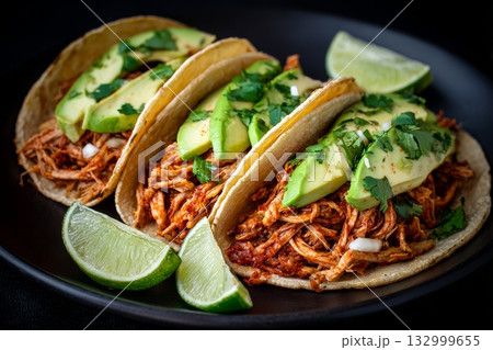 Delicious Chicken Tacos With Avocado and Lime on a Dark Slate Background Details matter. 132999655
