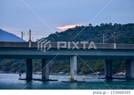 The seascape from the waterfront in Tung Chung, Hong Kong at sunset. Travel and nature scene. The seascape from the waterfront in Tung Chung, Hong Kong at sunset. Travel and nature scene. 133000395