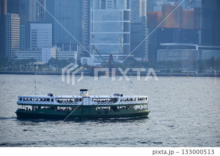 Star ferry sailing in the Victoria Harbor at Tsim Sha Tsui, Kowloon, Hong Kong. One of the public transportation in Hong Kong. Travel scene. 133000513