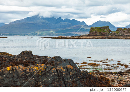 Historic Dunscaith Castle overlooking sea and Cuillin hills Scotland 133000675