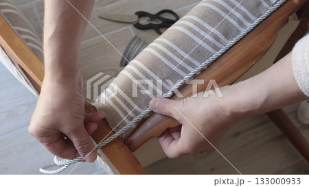 Anonymous person glues decorative braid. Antique furniture restoration. Crafts and hobbies. Anonymous person glues decorative braid. Antique furniture restoration. Crafts and hobbies. 133000933