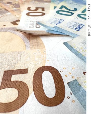 A close-up of a pile of different euro banknotes. Savings concept. 50 and 20 euro notes. 133001394