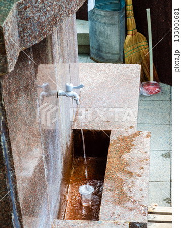 hot mineral water is poured into glass in Borjomi hot mineral water is poured into glass in Borjomi 133001681