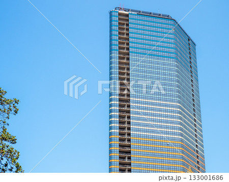 blue sky and glass skyscraper on sunny summer day blue sky and glass skyscraper on sunny summer day 133001686
