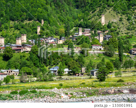 view of Mestia townlet on green slope in morning 133001991
