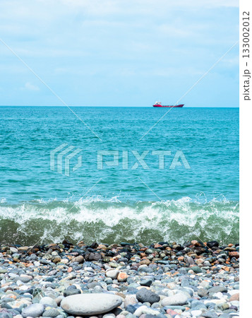 Black Sea with ship from pebble beach in Batumi Black Sea with ship from pebble beach in Batumi 133002012