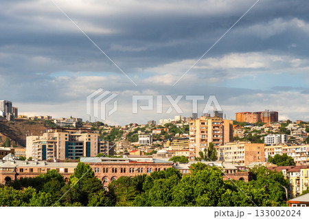 cloudy sky over sunlit district in Yerevan city cloudy sky over sunlit district in Yerevan city 133002024