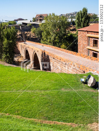 Red Bridge and house from red tuff in Yerevan city Red Bridge and house from red tuff in Yerevan city 133002312