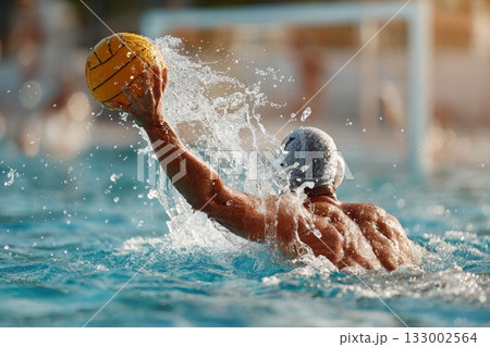 Male water polo player throwing ball in dynamic action during competitive match in pool 133002564