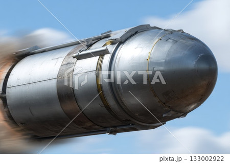 Close-up of metallic missile body in flight motion showcasing sleek design and aerodynamic features 133002922