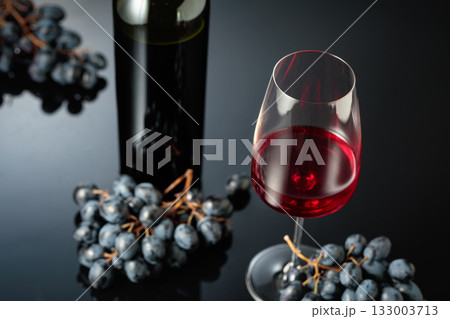 Red wine and juicy blue grapes. 133003713