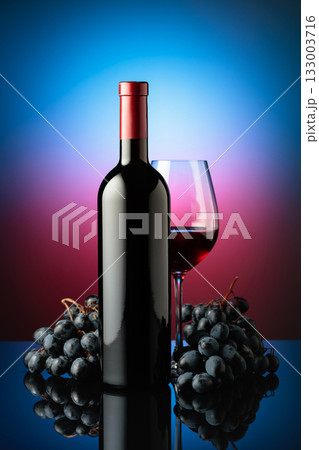 Red wine and juicy blue grapes. 133003716