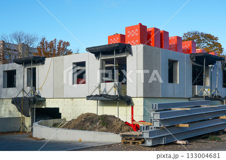 Modern apartment building construction with concrete walls, thermal insulation materials on rooftop 133004681