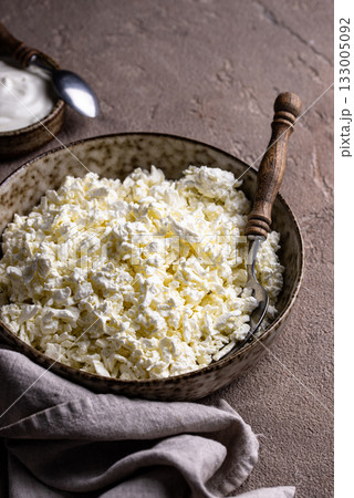 Cottage cheese on light background Cottage cheese on light background 133005092