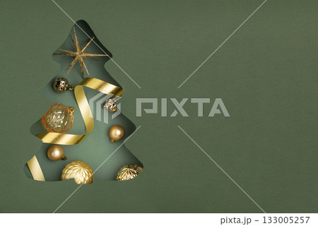 Christmas Tree Cutout Filled with Golden Ornaments on Green Background 133005257
